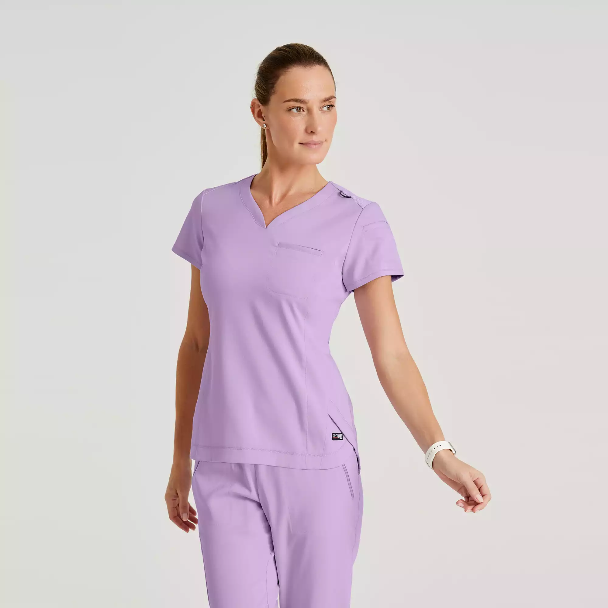 Greys-Anatomy-Spandex-Stretch-Womens-2-Pocket-V-Neck-Tuck-In-Top-GRST136-Purple-Freesia-01.webp Greys Anatomy Spandex Stretch Womens 2 Pocket V Neck Tuck In Top GRST136 Purple Freesia 01