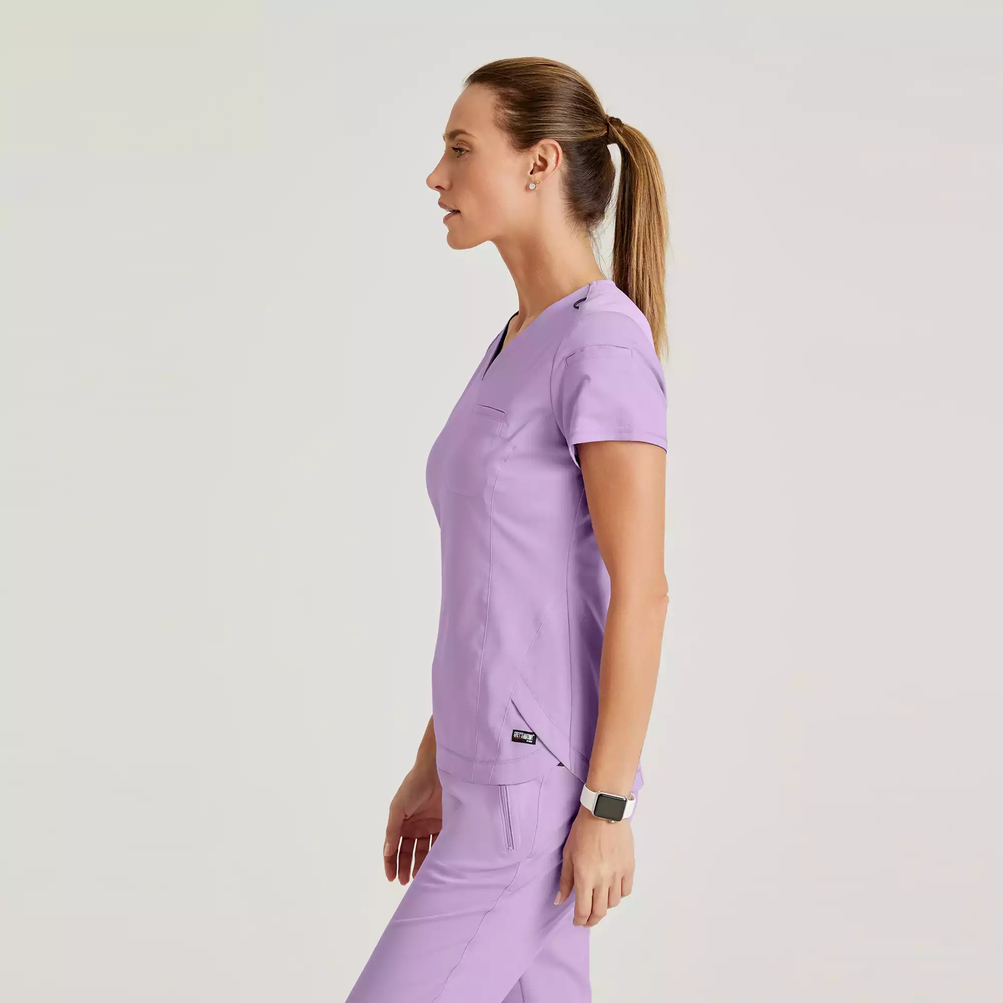 Greys-Anatomy-Spandex-Stretch-Womens-2-Pocket-V-Neck-Tuck-In-Top-GRST136-Purple-Freesia-03.webp Greys Anatomy Spandex Stretch Womens 2 Pocket V Neck Tuck In Top GRST136 Purple Freesia 03